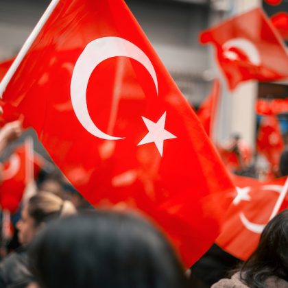 People waving turkish flag in the street at the Commemoration of Ataturk, Youth and Sports Day in Istanbul, Turkey