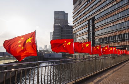 Row of Chinese flags on Huangpu river promenade, Shanghai, China